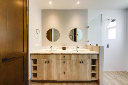 a bathroom with a sink and two mirrors at Cabo San Lucas Home Less Than 3 KM to Quivira Golf Club in Cabo San Lucas