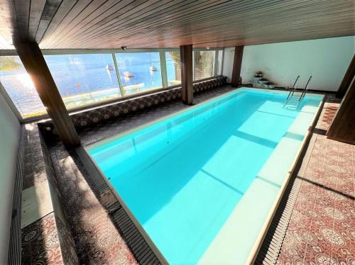 a swimming pool with a view of the water at Villa "Genovese al Lago" in Minusio