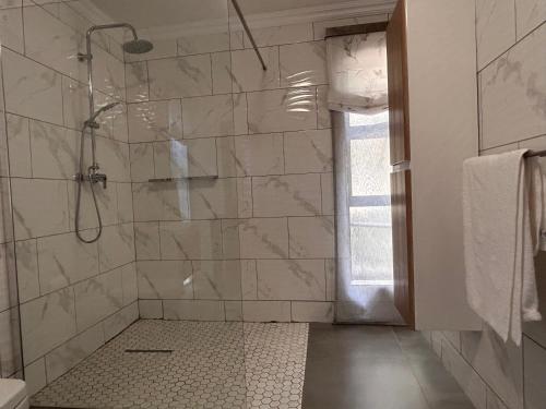 a bathroom with a shower with a glass door at Katlego in Bloemfontein