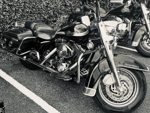 a black and white photo of a motorcycle parked in a parking lot at Ever Route 64 Brit Hotel Tarbes Ibos in Tarbes