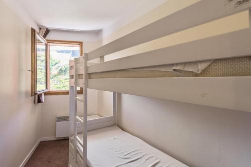 une chambre avec deux lits superposés et une fenêtre dans l'établissement Résidence Sépia - maeva Home - 3 pièces 7 pers Sélection MAE-5877, à Morzine