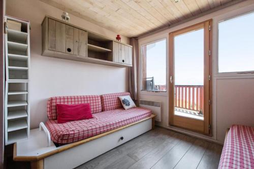 Cette petite chambre comprend un canapé et une fenêtre. dans l'établissement Résidence L'Ours Blanc - maeva Home - Appartement 2 Pièces 4 personnes - Sélection MAE-7573, à Huez