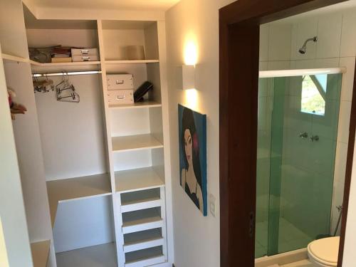 a bathroom with a walk in shower and a toilet at Paraíso Buziano 1 in Búzios