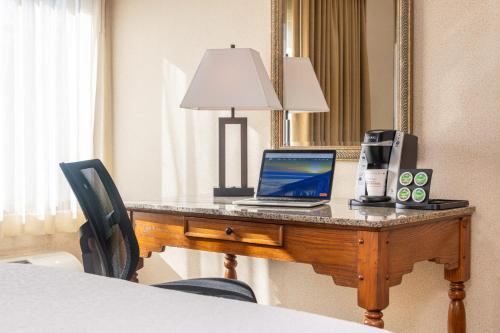 a laptop computer sitting on a desk in a hotel room at Best Western Plus Waterbury - Stowe in Waterbury