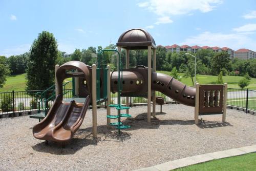 a playground with a slide in a park at Branson Condo with a Walkout and Elevator Access at Thousand Hills and next to 76 in Branson