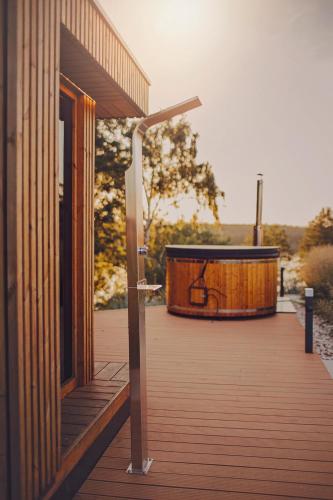a hot tub on a deck next to a building at Chce się być in Ślesin