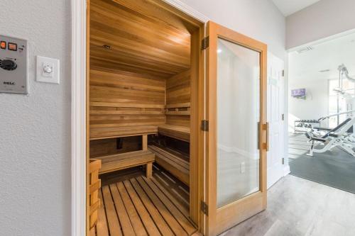 a walk in sauna with wooden walls and a glass door at Crystal Shores Unit 1405 in Gulf Shores