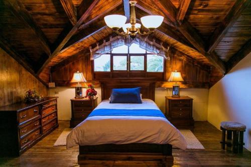 a bedroom with a large bed and a window at Hosteria Rumipamba De Las Rosas in San Miguel de Salcedo