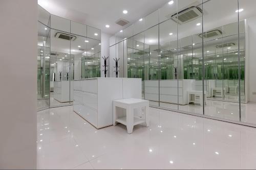 a large white room with a table and mirrors at Blue Elephant Villa Koh Phangan in Haad Pleayleam