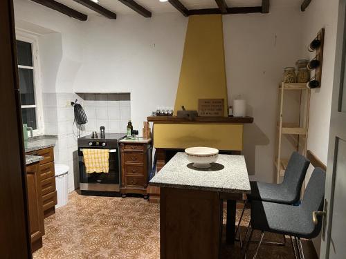 a kitchen with a stove and a counter top at Lovely Tuscan Mountain Village in Sassi