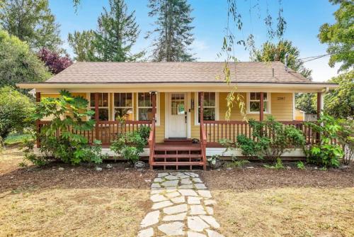 a small yellow house with a front porch at 118 - The Willow Tree Bungalow in Fall City