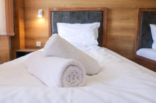 a pile of towels sitting on top of a bed at Family Hotel Gotse Delchev in Gotse Delchev