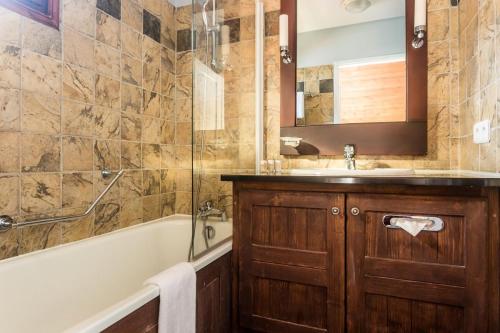 a bathroom with a tub and a sink and a bath tub at Résidence Les Arcs Le Village - maeva Home - Appartement Pièces Pers. Prest 90 in Bourg-Saint-Maurice