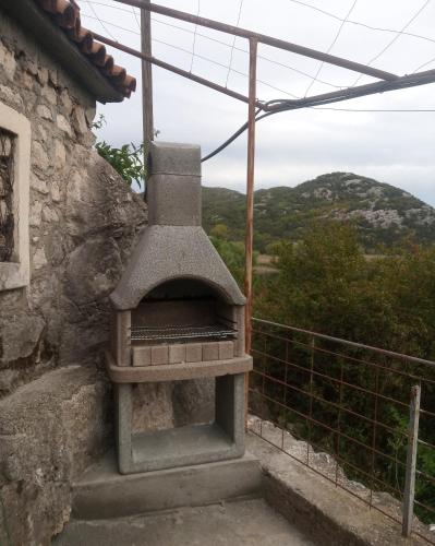 an outdoor oven sitting on the side of a building at Feel the Karuch in Cetinje