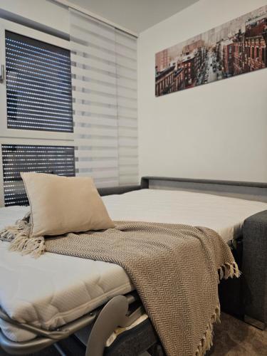 a hospital bed with a pillow and a chair at HIGH CLASS - Design Apartment - Favorite Place - Full Equipment - Public Transport in Nürnberg