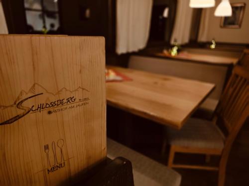 a wooden table and chair in a hotel room at Schlossberg in San Leonardo in Passiria