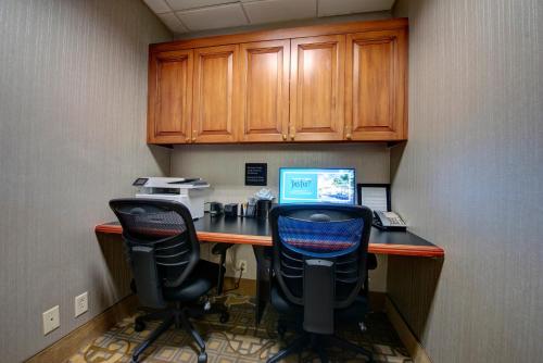 an office with two chairs and a desk with a computer at Hampton Inn & Suites By Hilton - Rockville Centre in Rockville Centre
