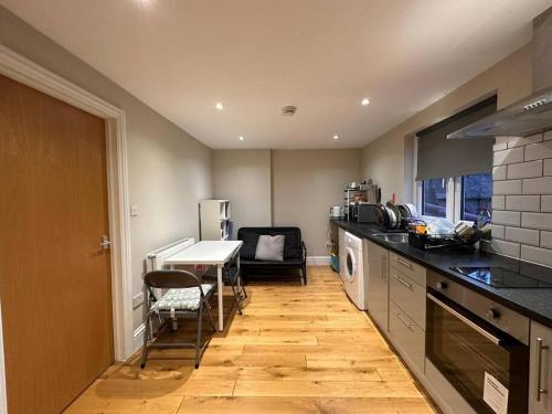 a kitchen with a counter and a table in it at Lovely flat in Brockley, SE4 in London