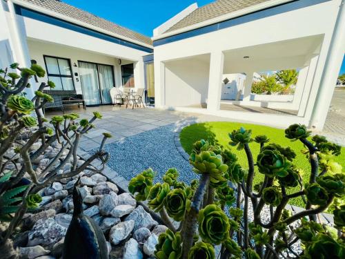 a house with a succulent garden in front of it at Little Haven in St Helena Bay