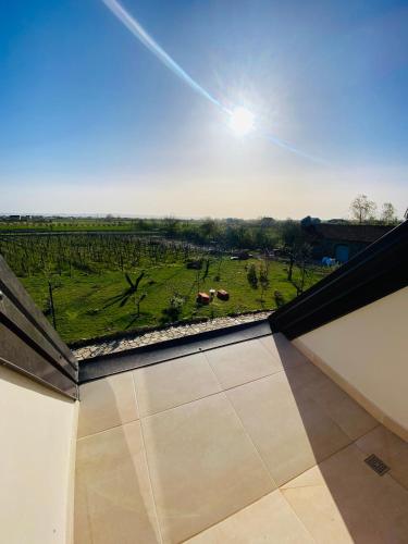 a view of a field from the balcony of a house at Lahuta e Vjeter Agroturizem in Laç