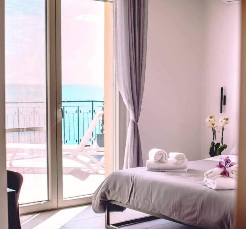 a bedroom with a bed and a sliding glass door at BLU MARINE in Catanzaro