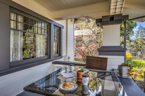a screened porch with a glass table on a house at Craftsman Inn in Calistoga