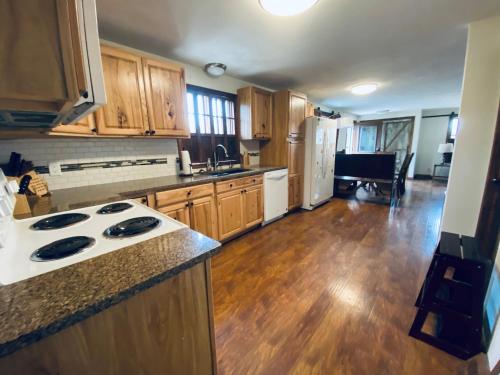 a kitchen with wooden cabinets and a counter top at The Farmhouse ranch in Stockton
