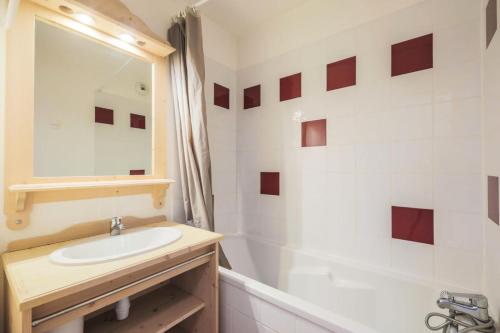 a bathroom with a sink and a tub and a mirror at Résidence Les Gentianes - maeva Home - Appartement 3 Pièces 6 Personnes - C 38 in Puy-Saint-Vincent