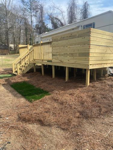 a house with a wooden deck in a yard at Romantic getaway in Decatur