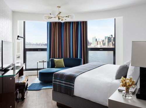 a bedroom with a bed and a chair and a window at Graduate by Hilton New York in New York
