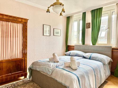 a bedroom with a large bed with green curtains at 110 m2 Rooftop Apartment - St Stephen's Cathedral View in Vienna