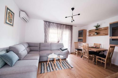 a living room with a couch and a table at Apartment Jazz in Požega