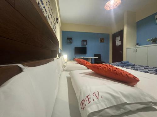 Ένα ή περισσότερα κρεβάτια σε δωμάτιο στο Pousada Villa Flamboyant
