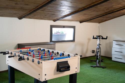a large foosball table in a room with a gym at Corso Italia Luxury Suite in Fondi
