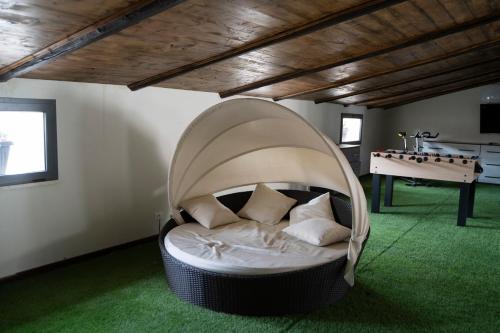 a couch in a room with a ping pong table at Corso Italia Luxury Suite in Fondi