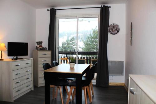 une salle à manger avec une table et des chaises et une fenêtre dans l'établissement Résidence Les Issarts - APPARTEMENT AU PIED DES PISTES MAE-9761, à Saint-Étienne-en-Dévoluy