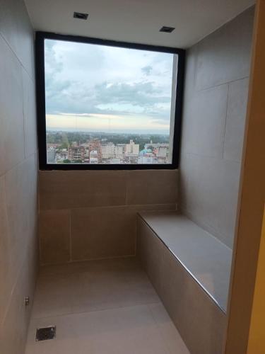 a shower with a large window in a bathroom at Garden Plaza in San Miguel de Tucumán