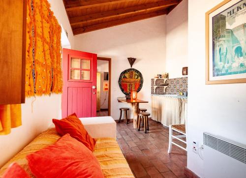 a living room with a couch and a table at Casa Bene Holiday Home in Aljezur