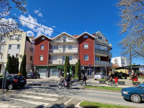 a person riding a bike on a city street at Apartman Trend 17 in Vrnjačka Banja