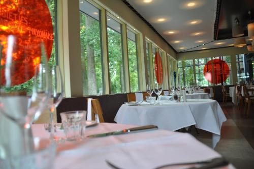 a dining room with tables with white tablecloths at Droste's Herberg in Tubbergen