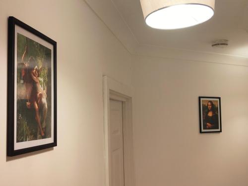 a painting on the wall in a room with a lamp at Unique and luxury city center apartment with free parking in Southampton