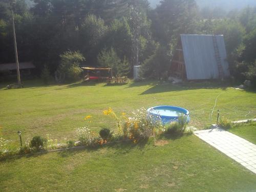 a yard with a swimming pool in the grass at Rusaliite Adventure House in Bachevo