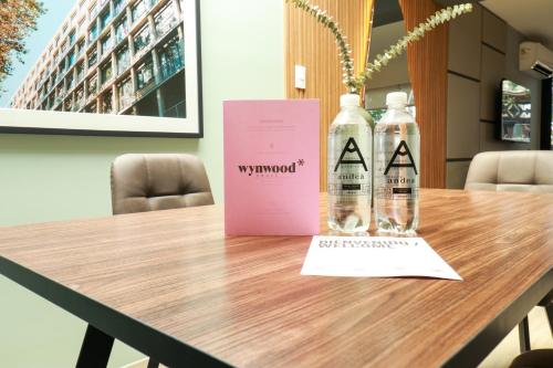 two bottles of alcohol sitting on a table at Primera Parada By Wynwood House in Lima