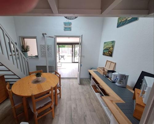 a living room with a table and chairs and a dining room at Bright house with terrace and garden in Camiers