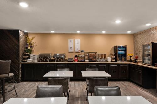 a restaurant with tables and chairs and a counter at Wyndham Garden Galena Hotel & Day Spa in Galena