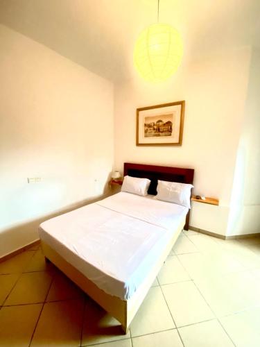 a bedroom with a large bed in a room at DAMAS in Douala