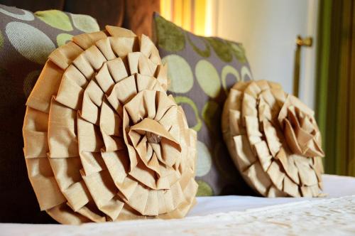 two wooden objects on top of a bed at The Hotel Commodore in Llandrindod Wells