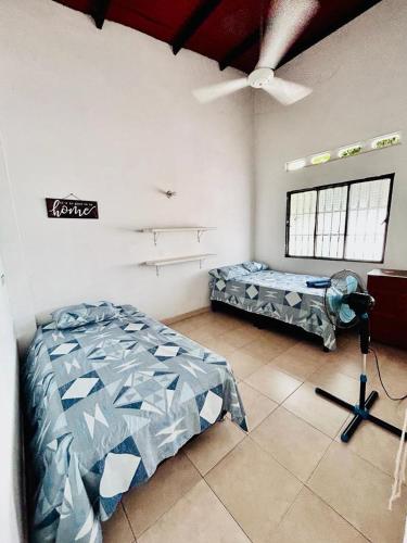 a bedroom with a bed and a ceiling fan at CASA HONDANA in Honda