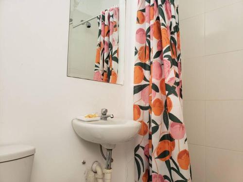 La salle de bains est pourvue d'un lavabo, d'un miroir et de toilettes. dans l'établissement Bujama vista al mar, à Asia