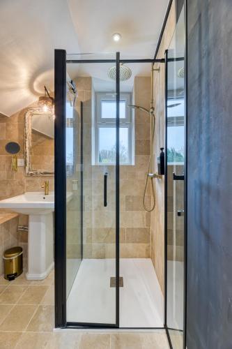 une douche en verre dans une salle de bain avec un lavabo dans l'établissement Appartement « le casier » vue mer Fécamp, à Fécamp